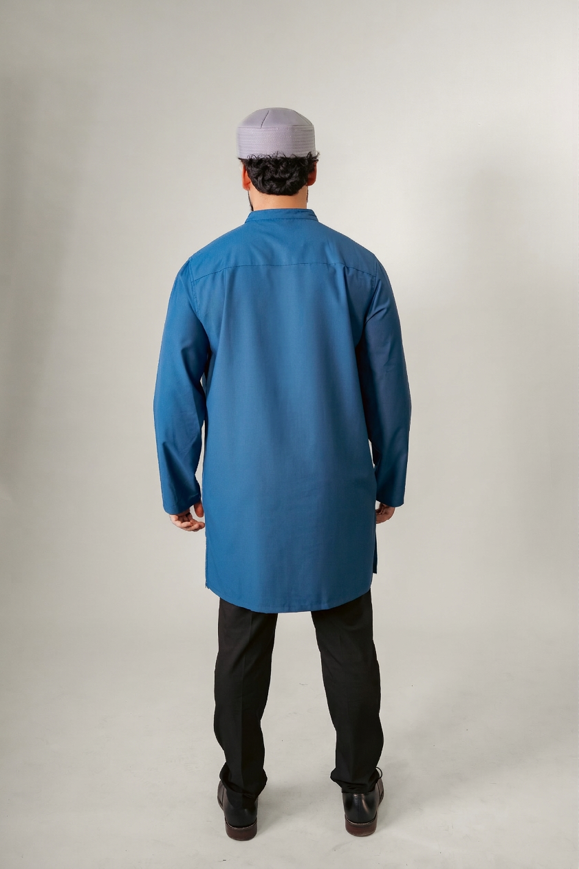 Man in a blue hooded robe holding glasses and a black bag against a white background.