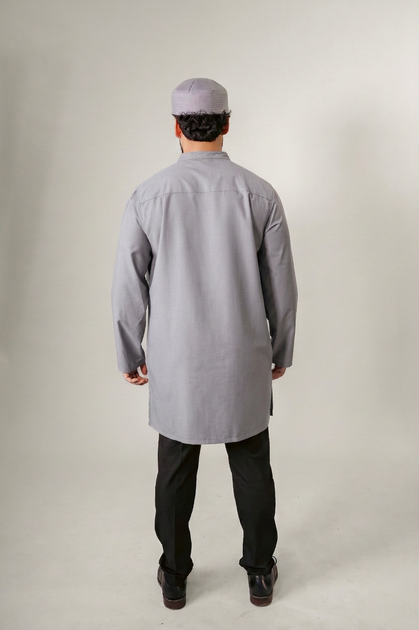Man in a blue hooded robe holding glasses and a black bag against a white background.