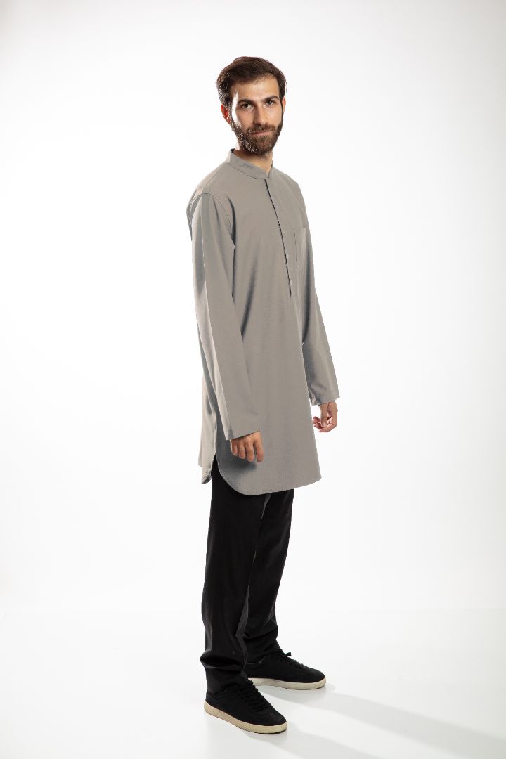 Man in a blue hooded robe holding glasses and a black bag against a white background.