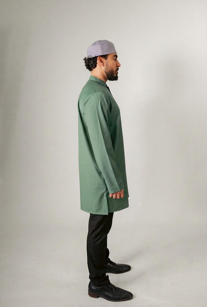 A person in a dark hooded robe, holding a string of beads, standing with back turned.